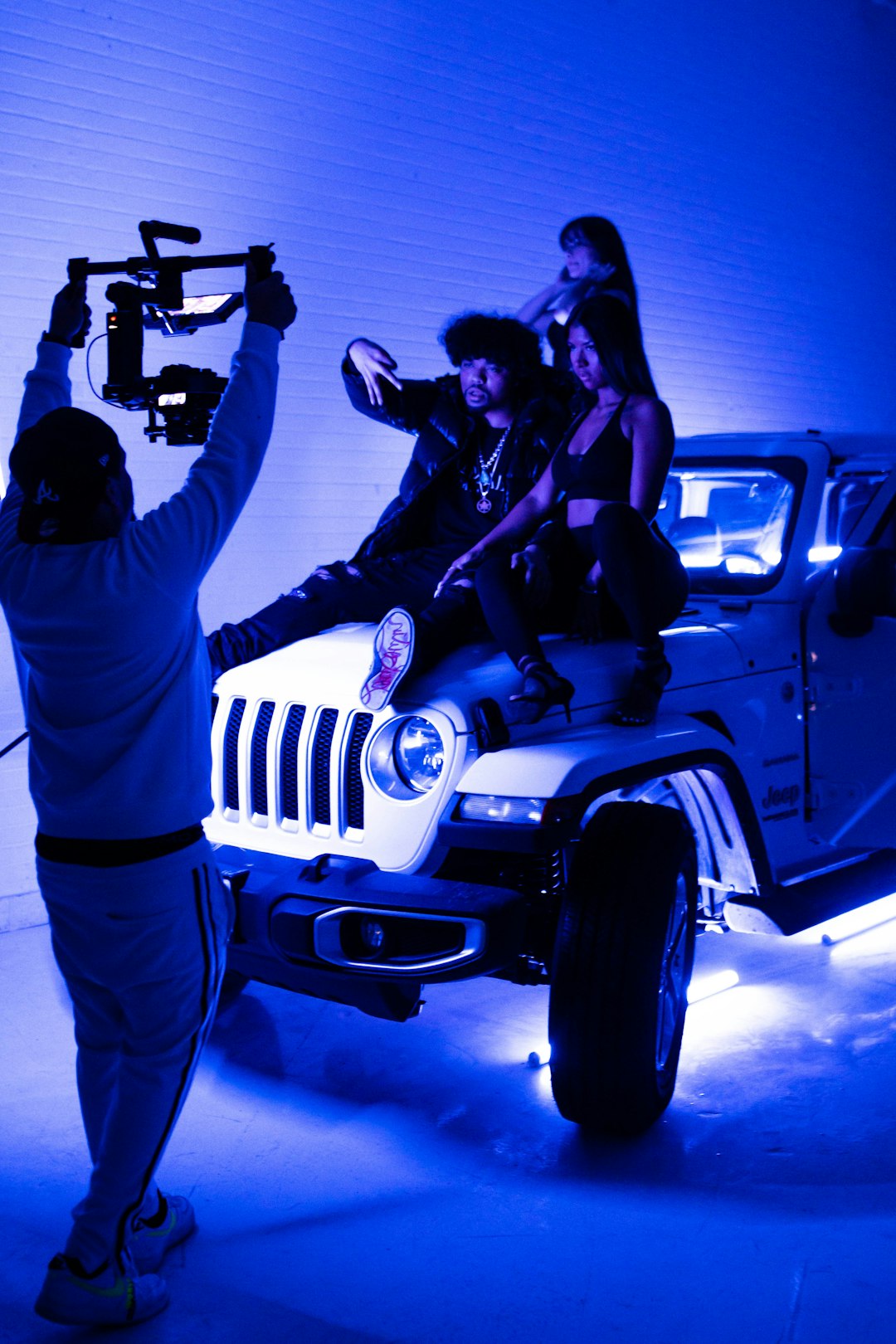 man and woman kissing on white jeep wrangler