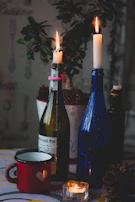 A couple exchanging a personalized wine bottle at a cozy candlelit dinner.
