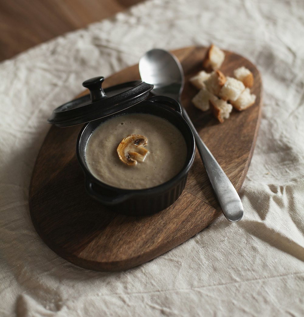 stainless steel spoon on brown wooden round plate