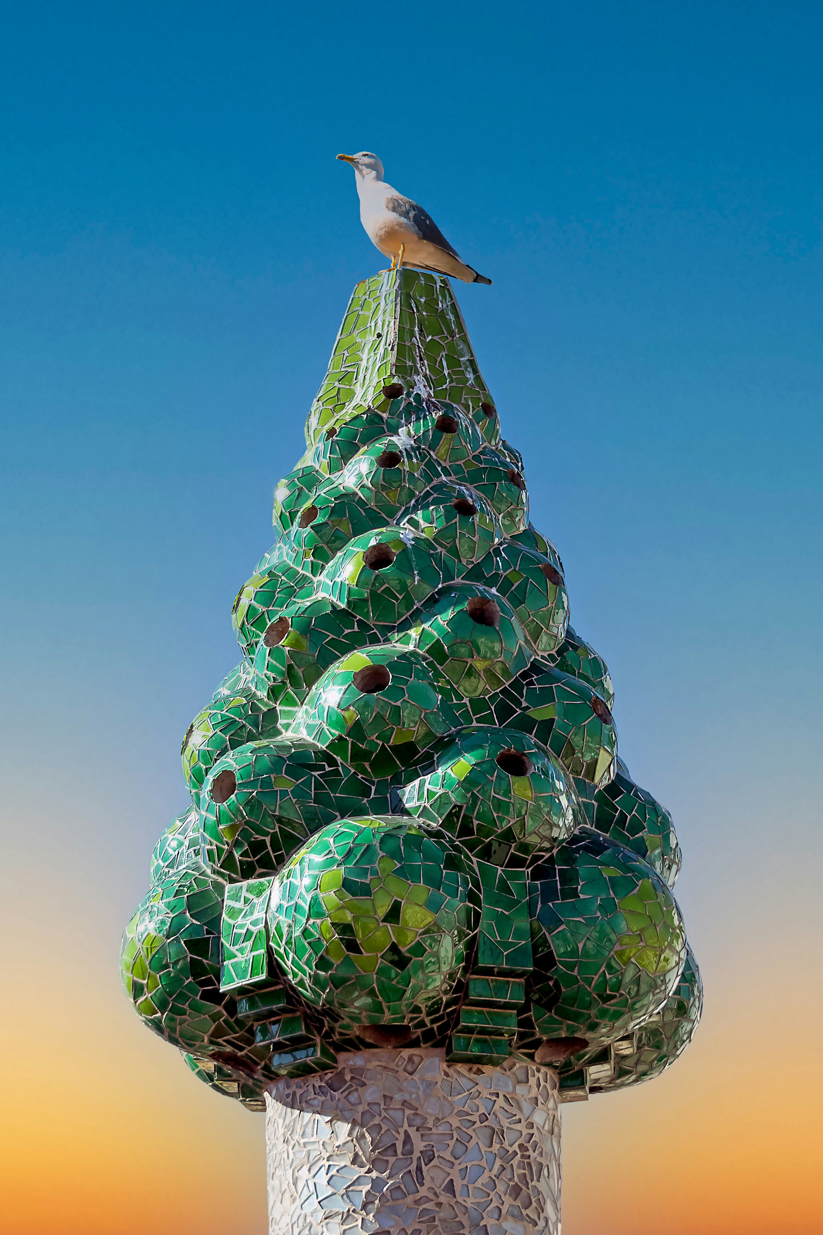 black bird on green and yellow glass ball