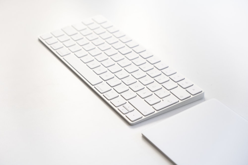 Weiße Apple-Tastatur auf weißem Tisch