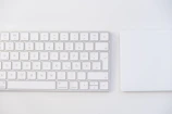 white apple keyboard on white table