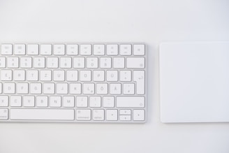 white apple keyboard on white table