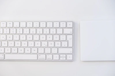 white apple keyboard on white table