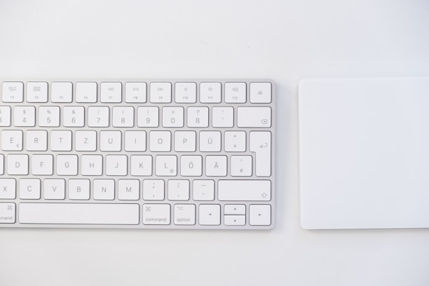 white apple keyboard on white table