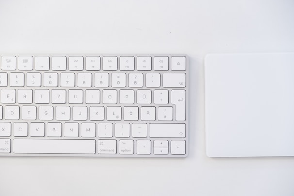 white apple keyboard on white table