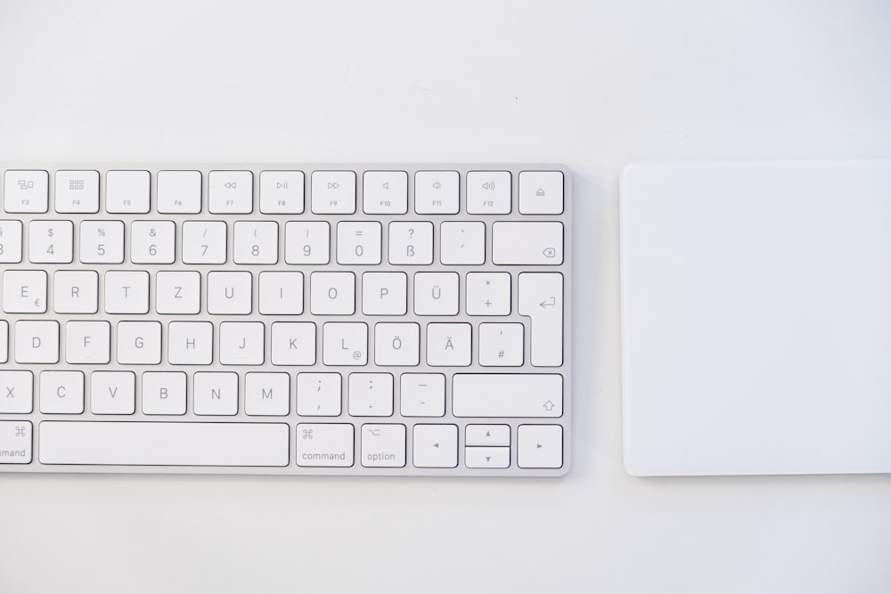 white apple keyboard on white table