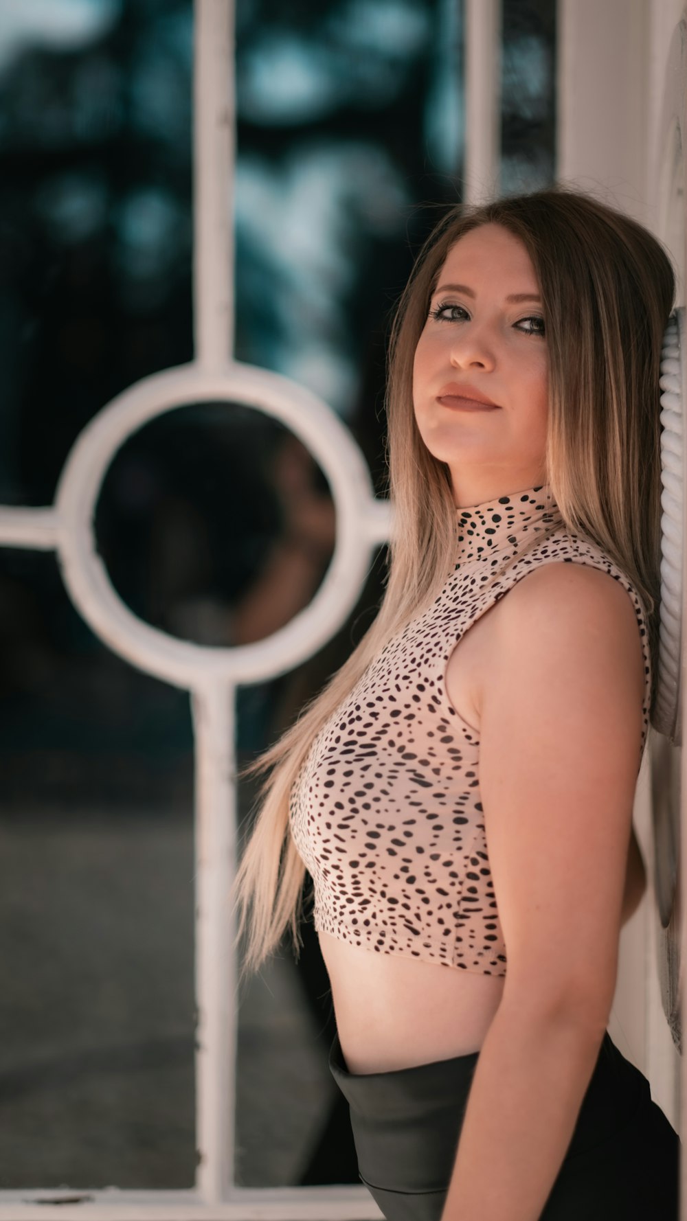 woman in white and black polka dot tank top