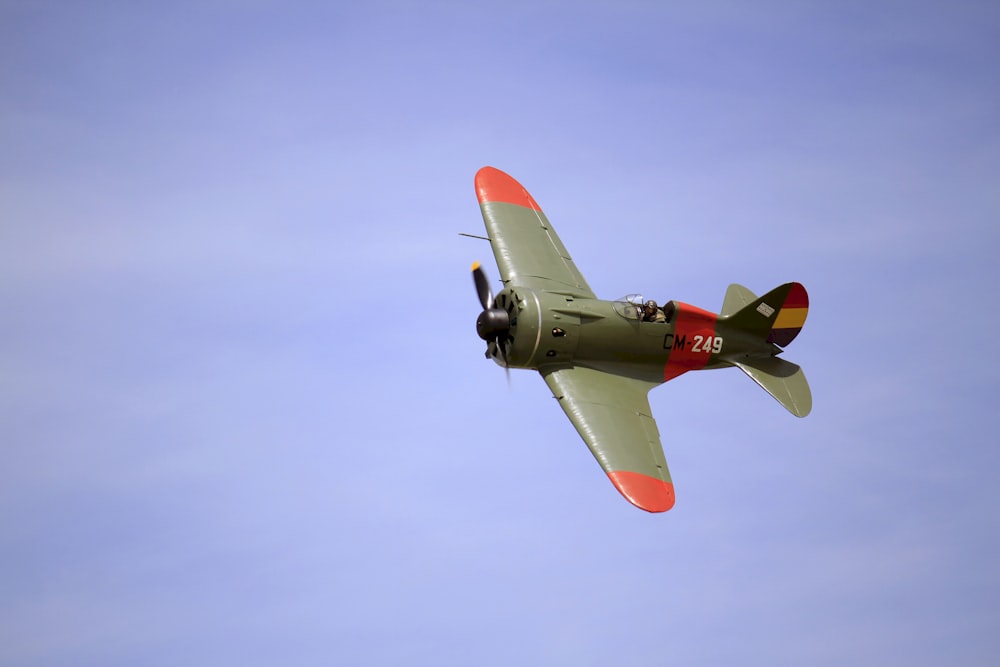 red and white jet plane in mid air during daytime