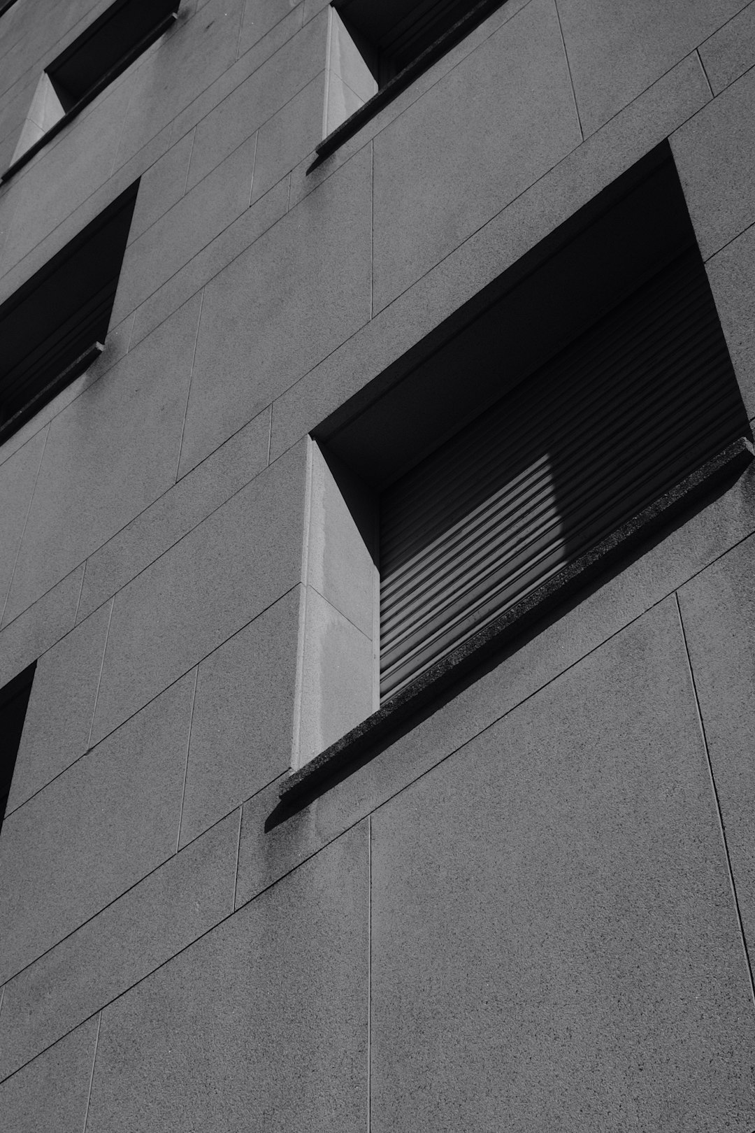 black window blinds on gray concrete building