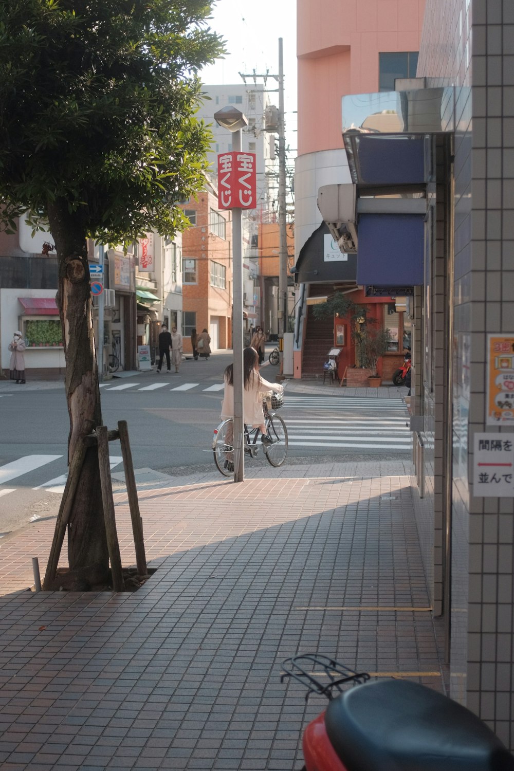man in white shirt riding bicycle on sidewalk during daytime