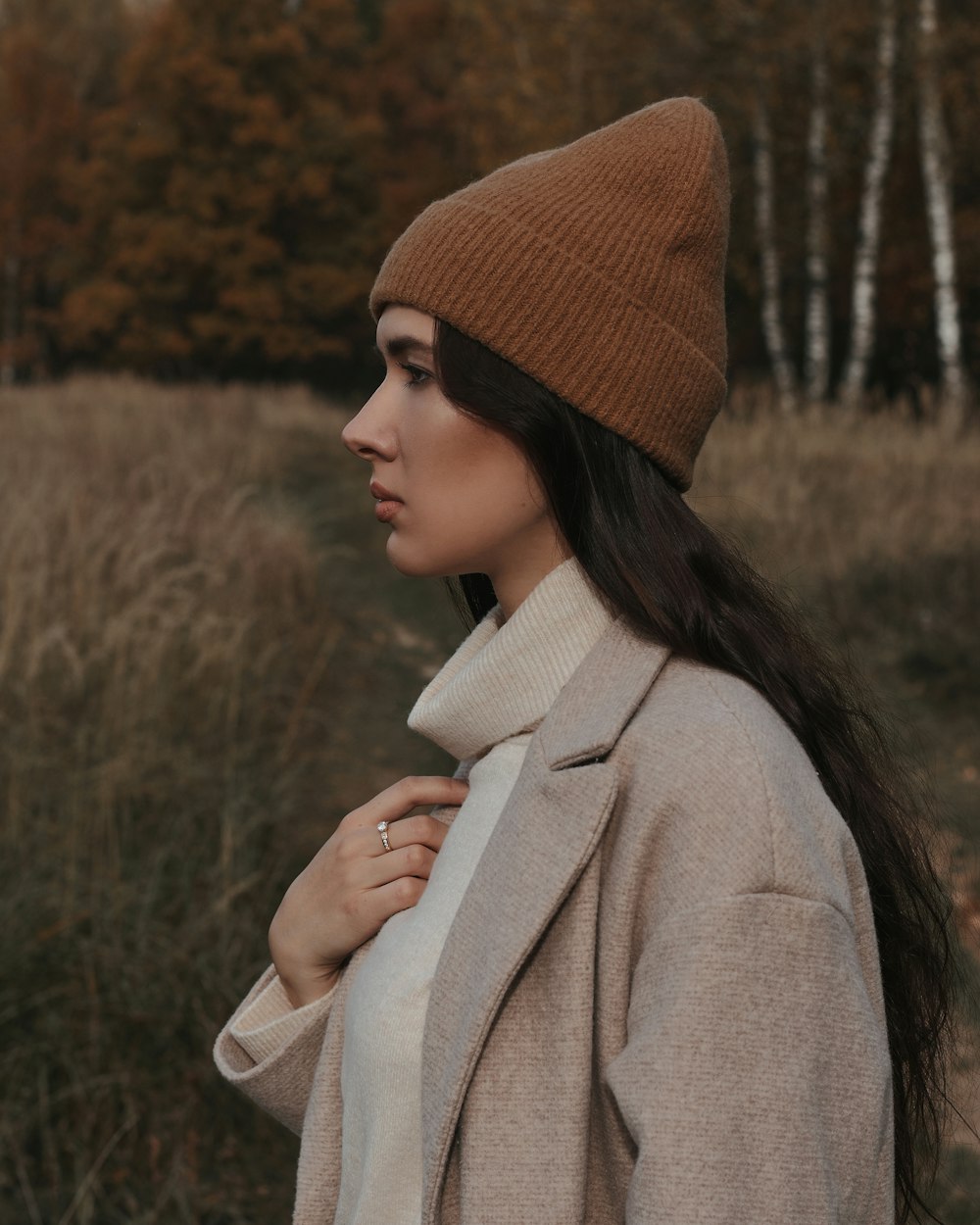 woman in brown knit cap and brown coat