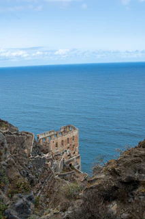 A dark, crumbling empire built on six pillars sinking slowly beneath turbulent waters.