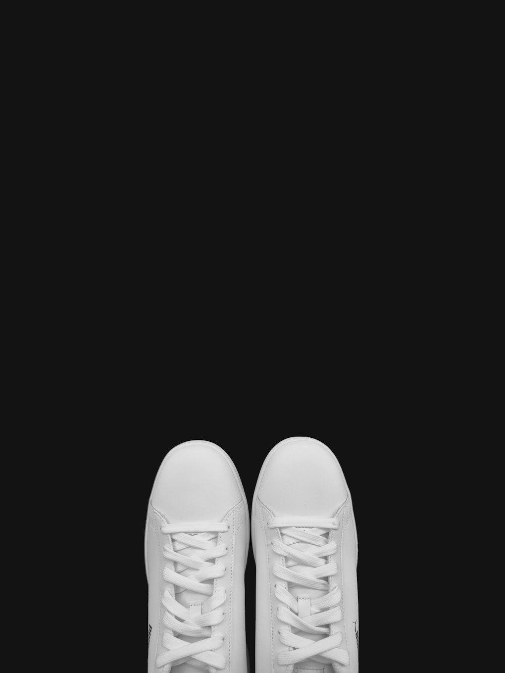 person wearing white leather shoes