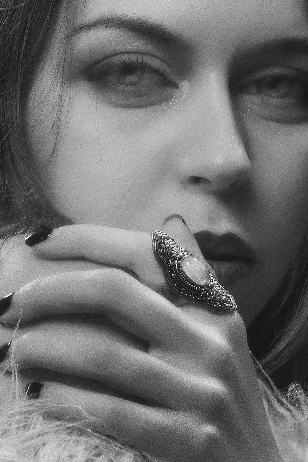 grayscale photo of woman wearing silver and black ring