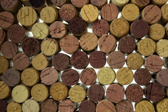 Close-up of various wine corks arranged on a rustic wooden table.