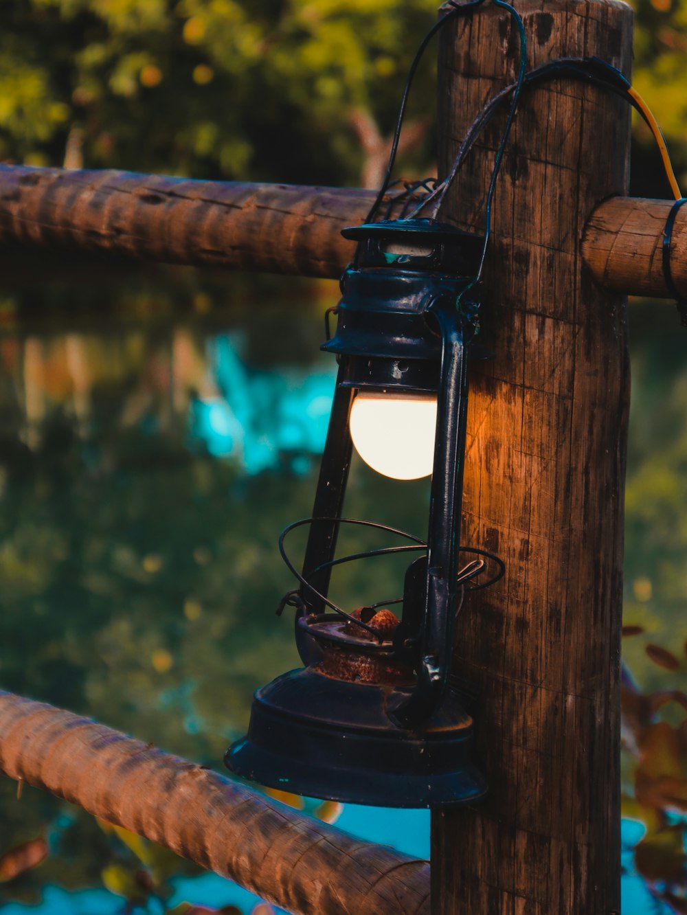 black lantern on brown wooden post