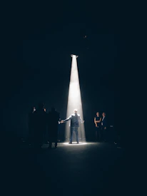 Stephen passionately acting on stage, spotlight highlighting his focused expression.