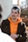 man in black and orange zip up jacket smiling
