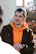man in black and orange zip up jacket smiling