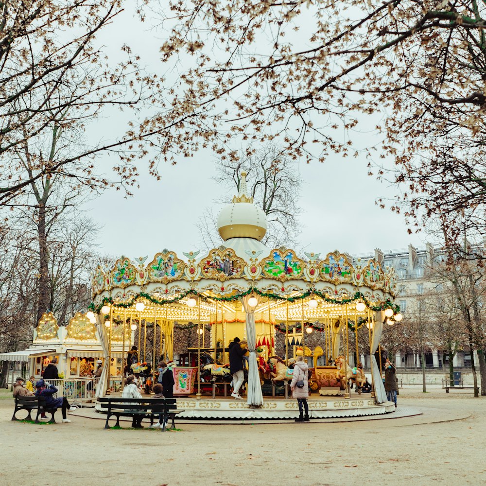 people sitting on bench under leafless trees during daytime