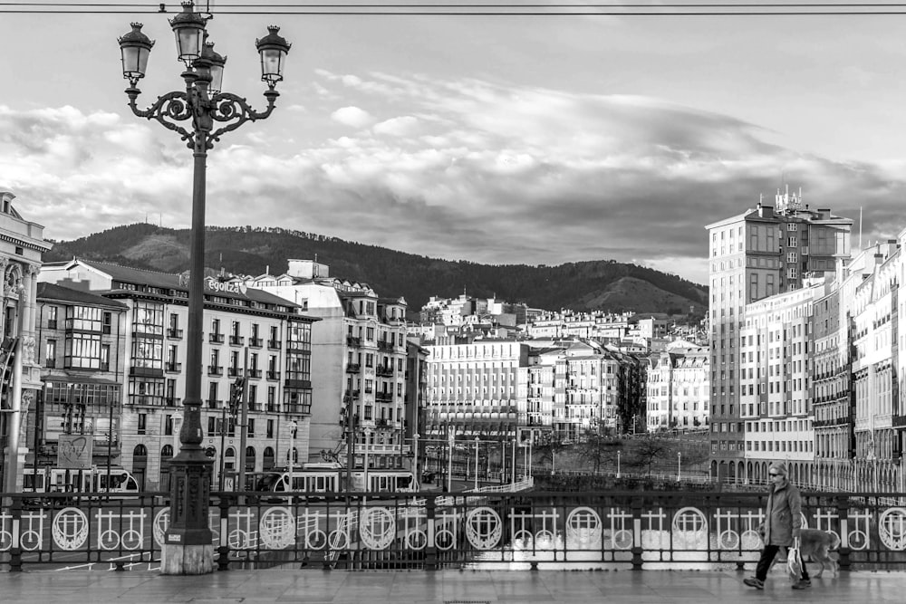 grayscale photo of city buildings near body of water