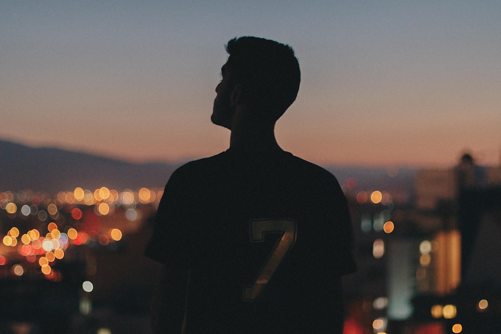 silhouette of man standing during sunset