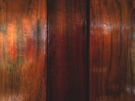 A close-up of premium decorative materials displayed on a wooden table in a well-lit setting.