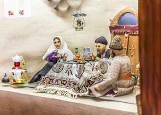 A warmly lit photo of travelers sharing tea with locals in a vibrant Rajasthan village.