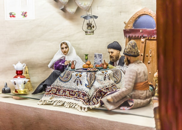 A warm scene of a sathi+ companion sharing a laugh with an elderly woman over tea in a cozy living room.
