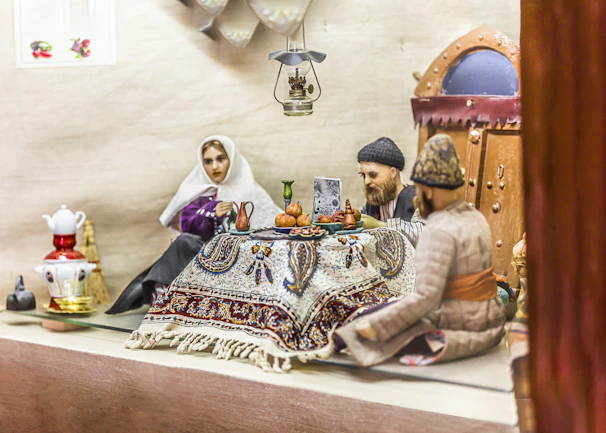 A warmly lit photo of travelers sharing tea with locals in a vibrant Rajasthan village.
