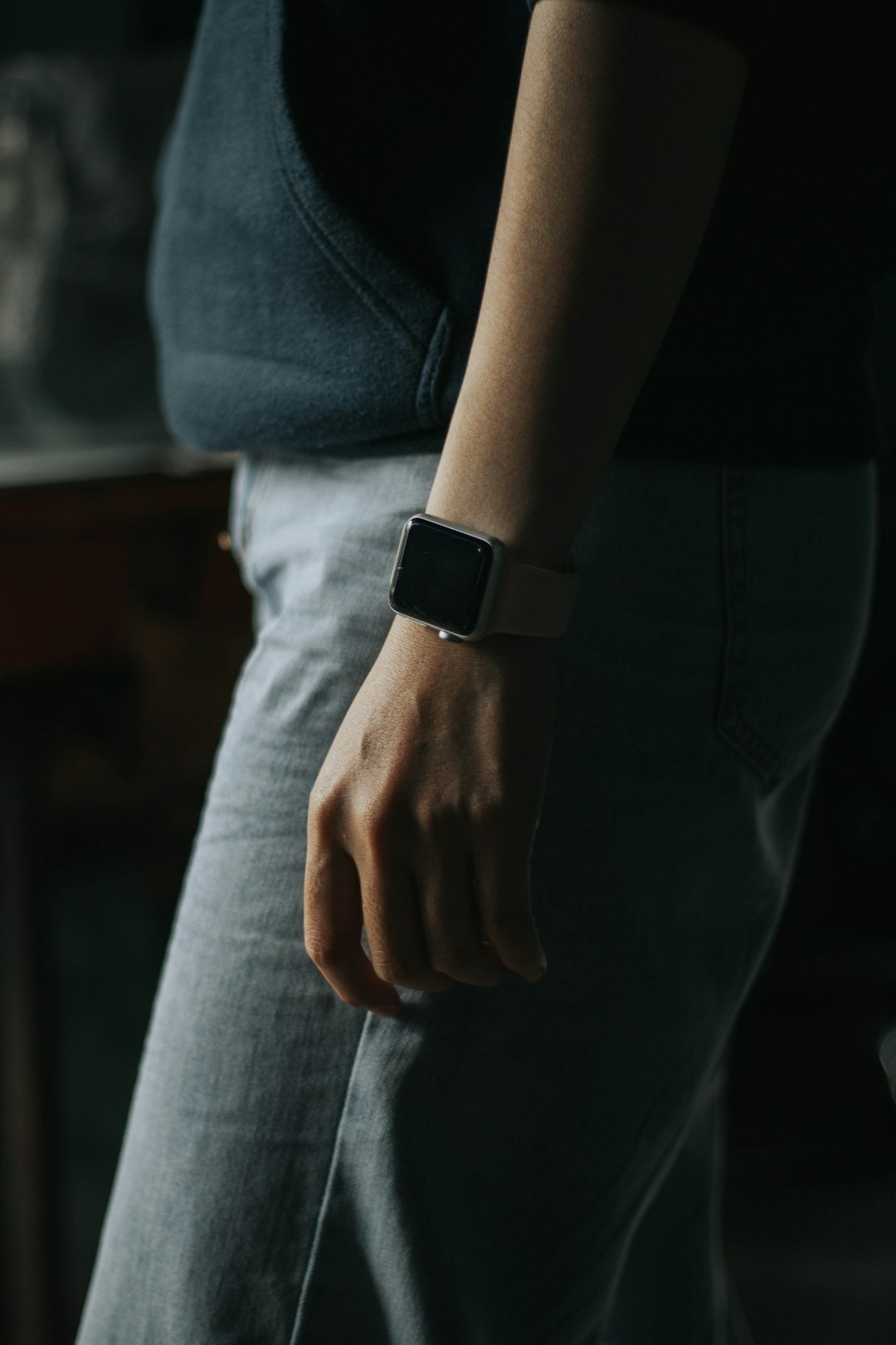 person in gray denim jeans wearing black apple watch