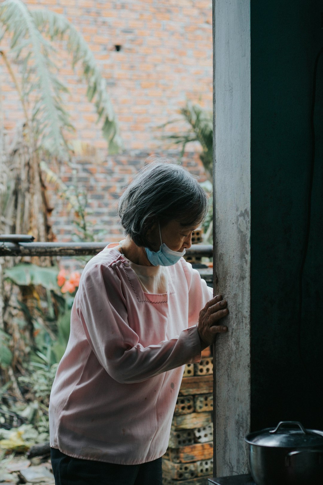 woman in pink hoodie wearing black headphones