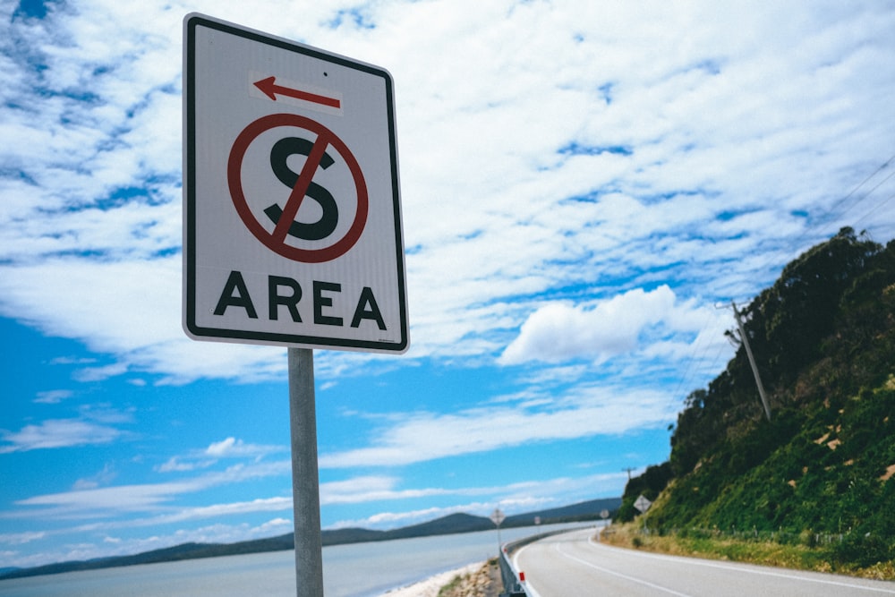 no smoking sign on road during daytime