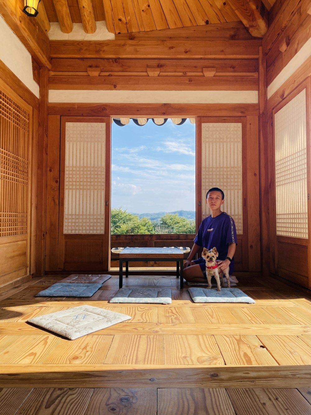 man in black shirt sitting on brown wooden bench