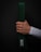 A hand holds a green martial arts belt against a dark background. The belt displays a patch with the word 'BLITZ' in white letters. The hand is clenched around the folded belt, showing visible veins and a light skin tone. The person is wearing a white long-sleeved garment.