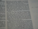 A close-up view of a printed text on a page, possibly from a religious book, focusing on specific verses with a clear column layout. The text appears to be discussing historical events involving tribes.