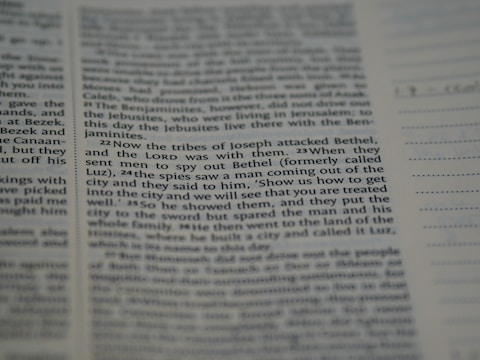 A close-up view of a printed text on a page, possibly from a religious book, focusing on specific verses with a clear column layout. The text appears to be discussing historical events involving tribes.