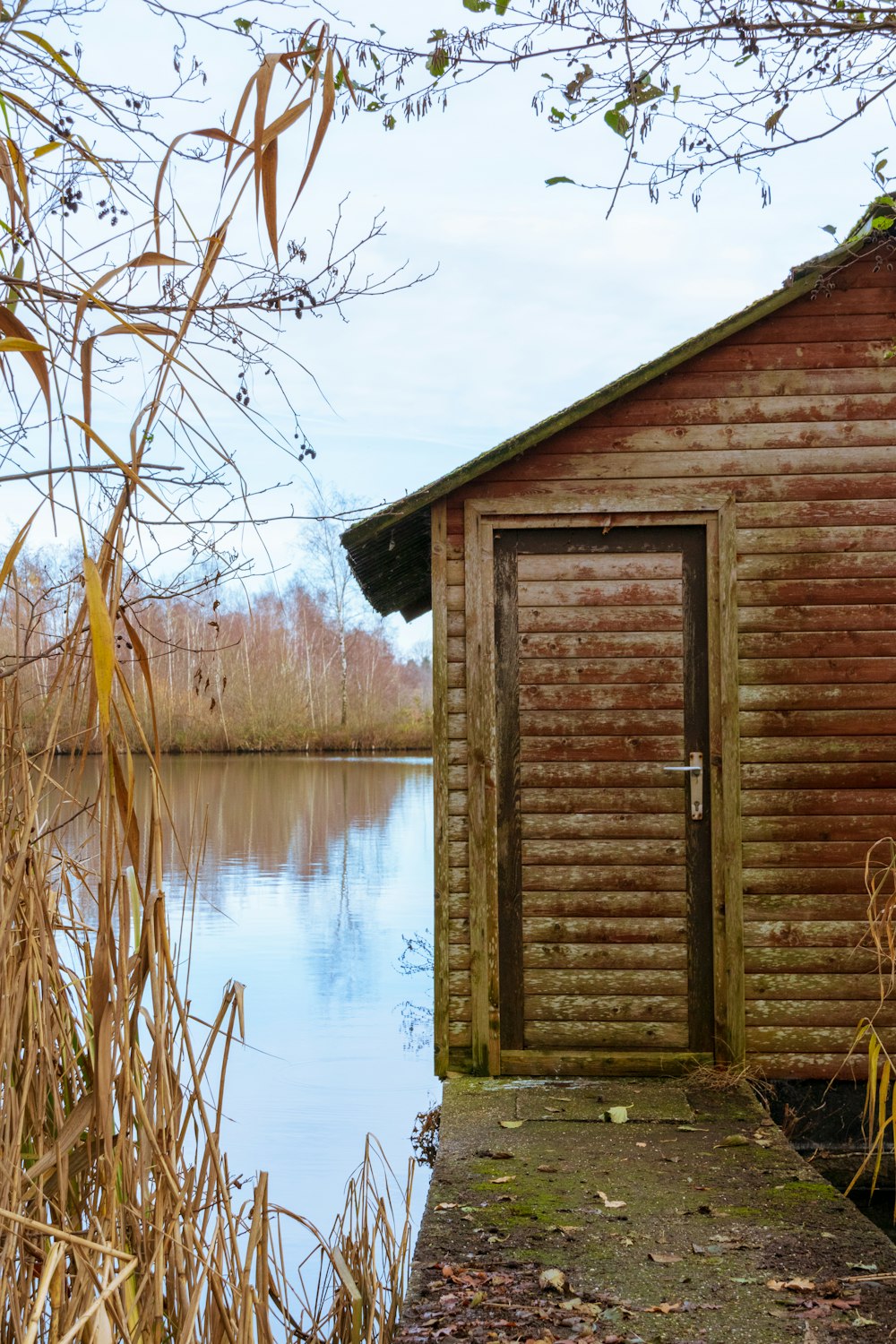 a wooden building sitting next to a body of water