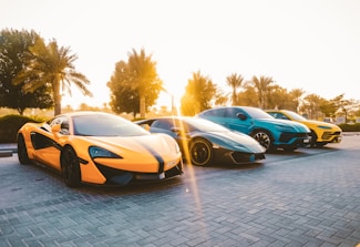 yellow and black lamborghini aventador parked on gray brick floor during daytime