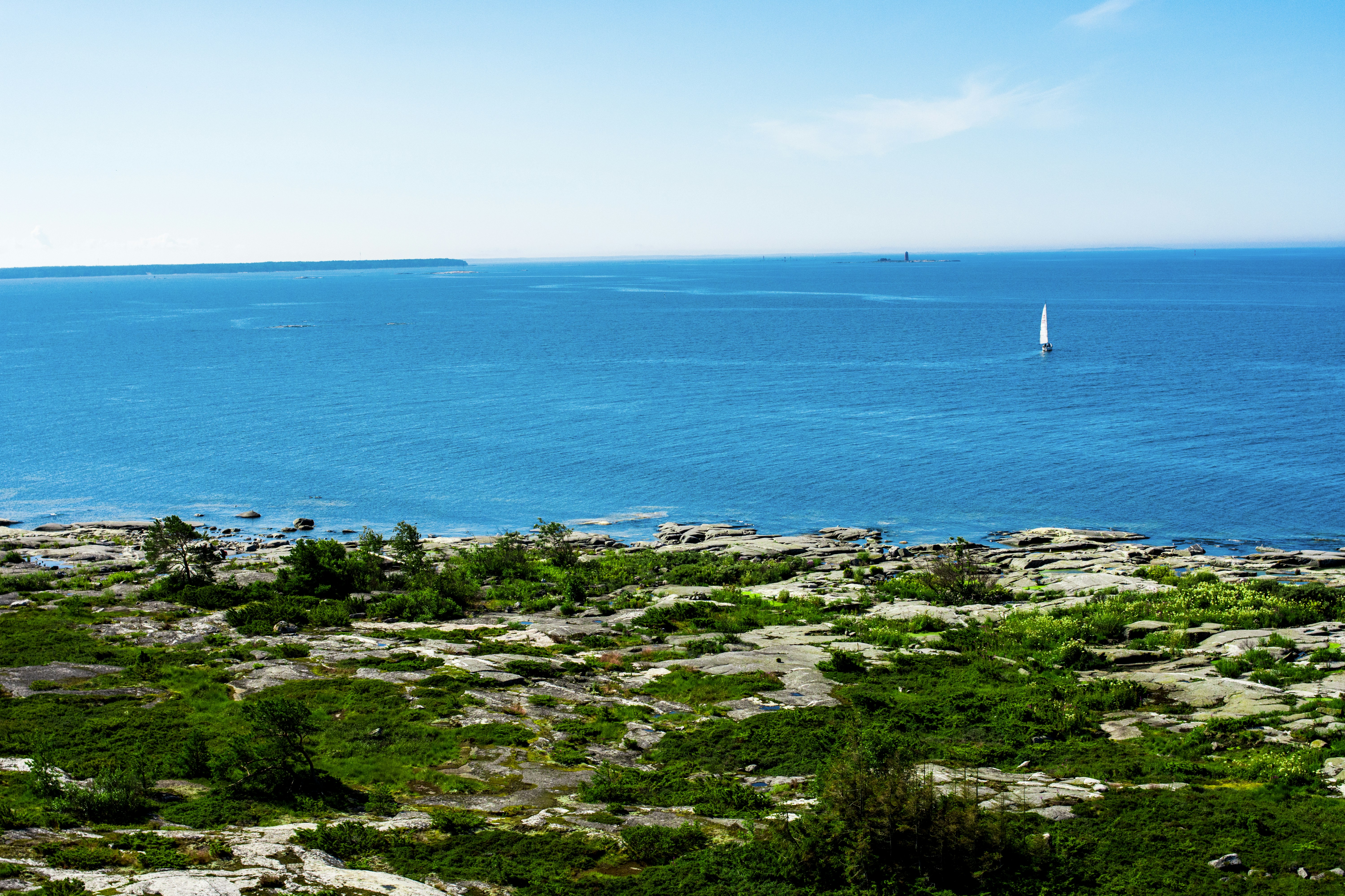 green grass field near body of water during daytime, Vistas del archipiélago finés.