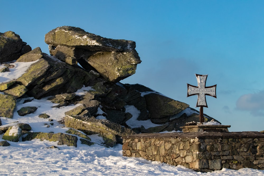 brown cross on gray rock formation during daytime