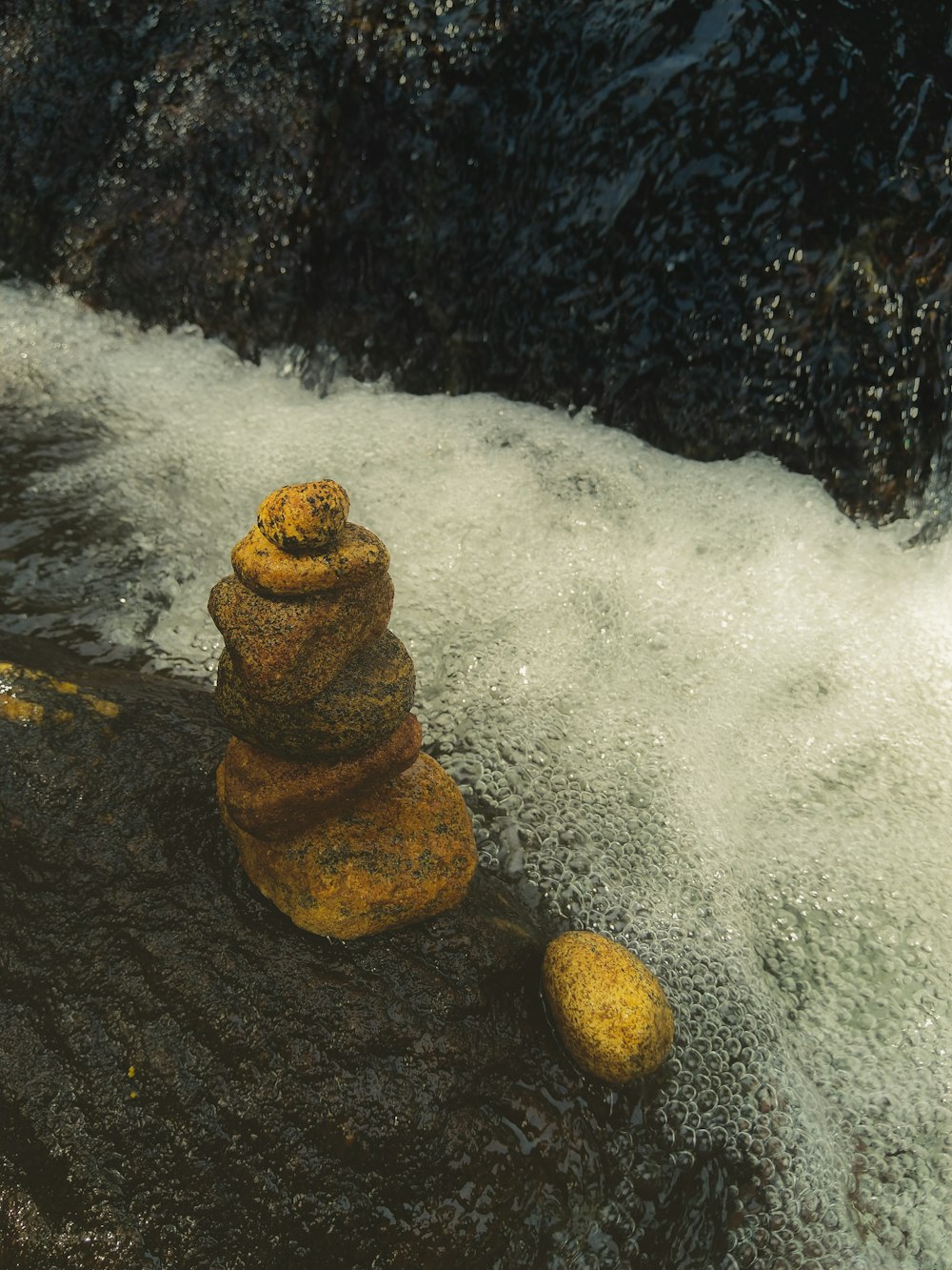 brown rock formation on water