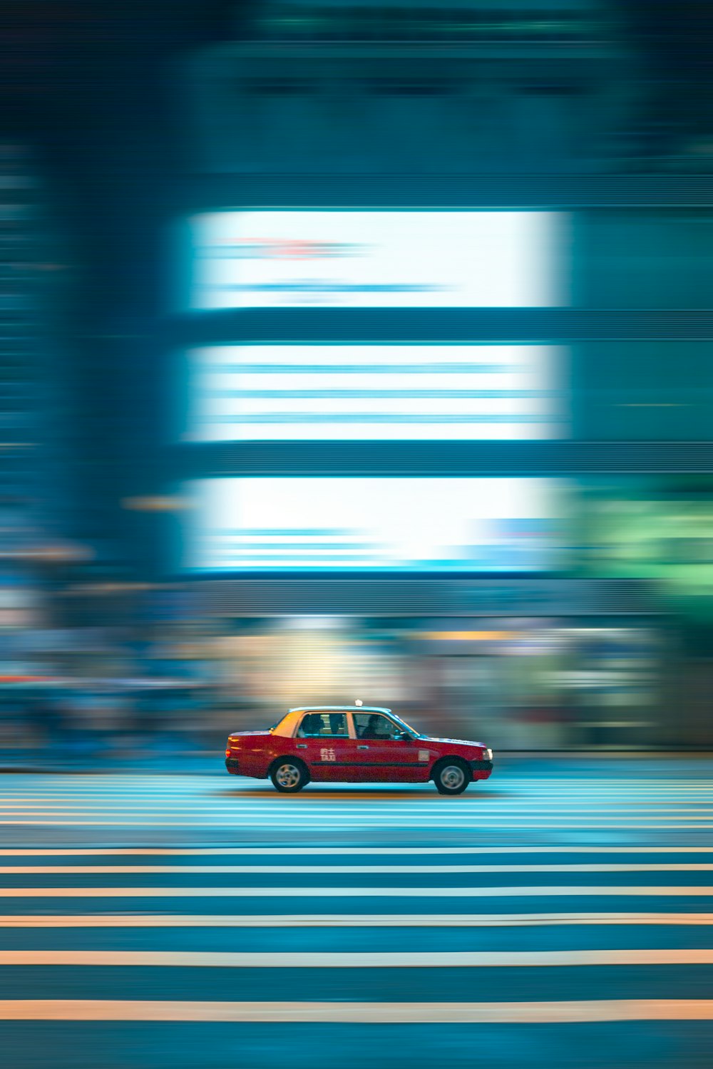 red sedan on road during daytime