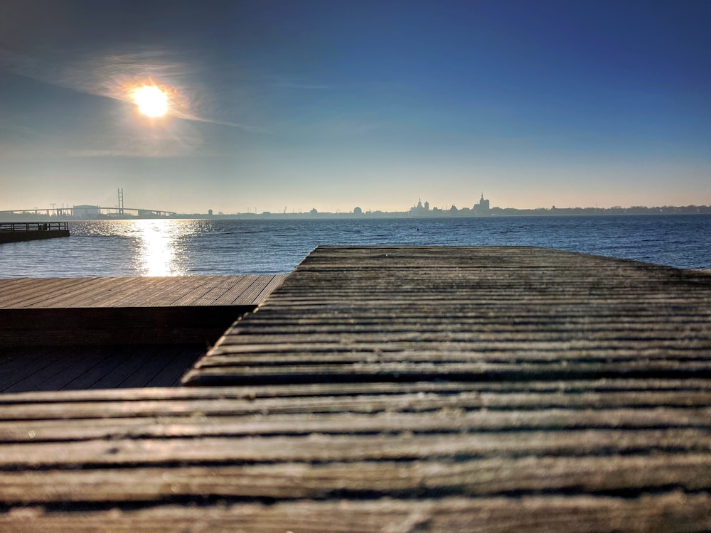 brown wooden dock on sea during daytime