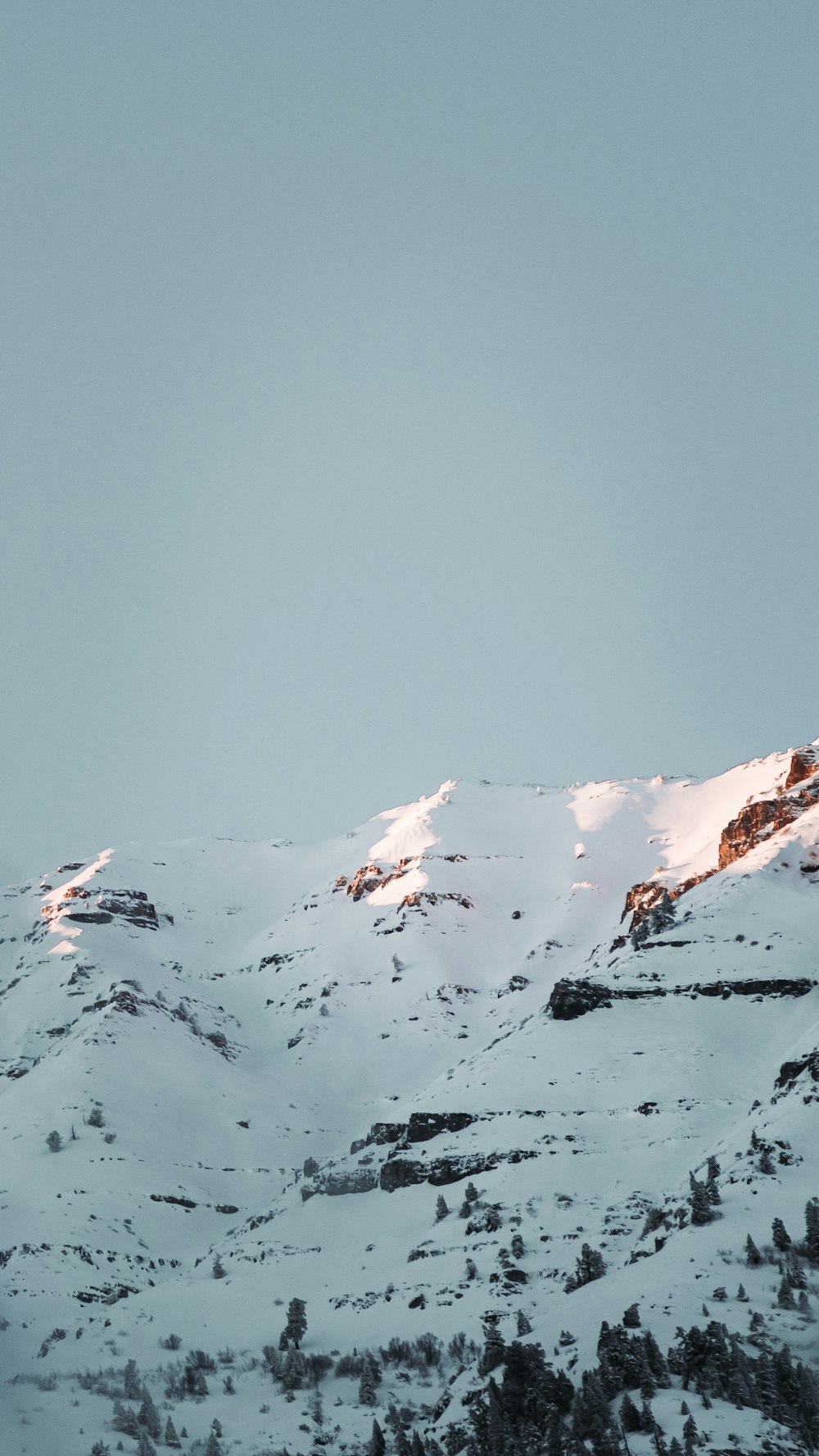 snow covered mountain under blue sky during daytime