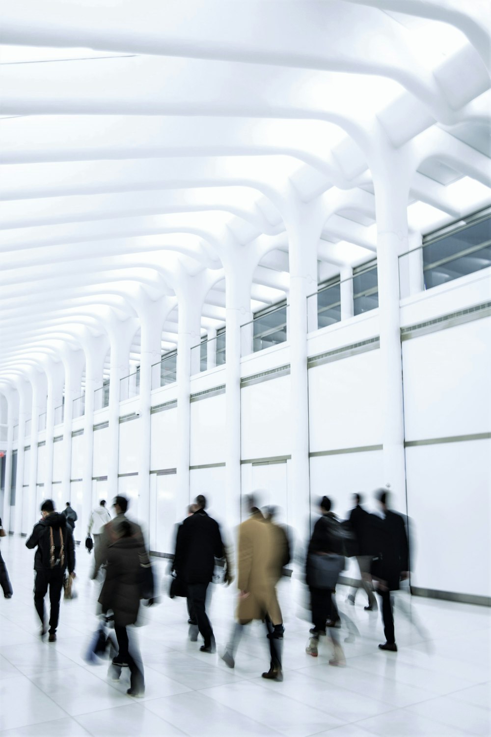 people walking on white hallway