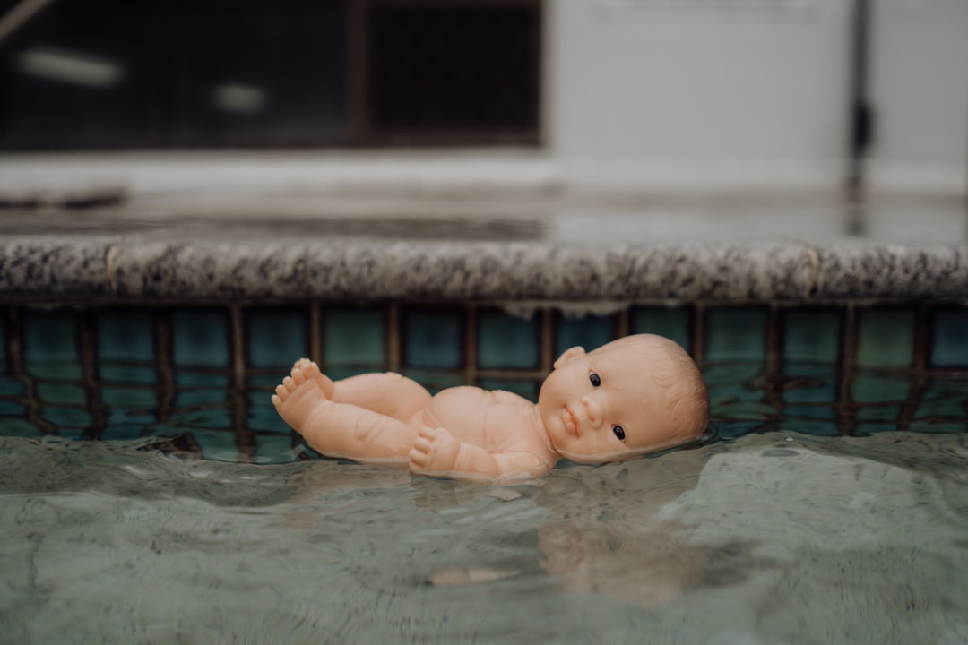 baby in water during daytime