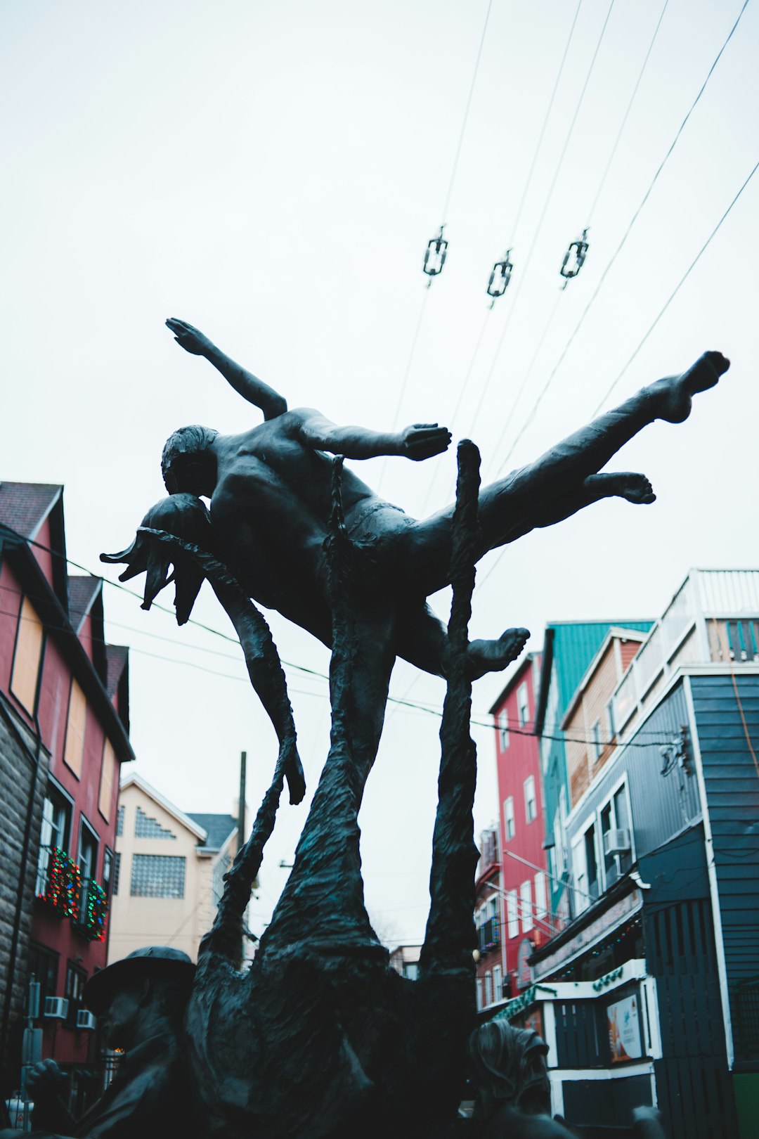 black statue of man in the middle of the city