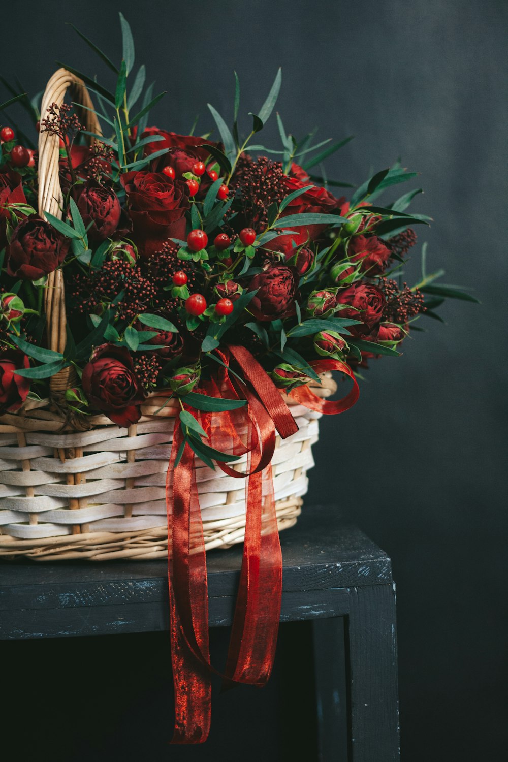 red flowers on brown woven basket